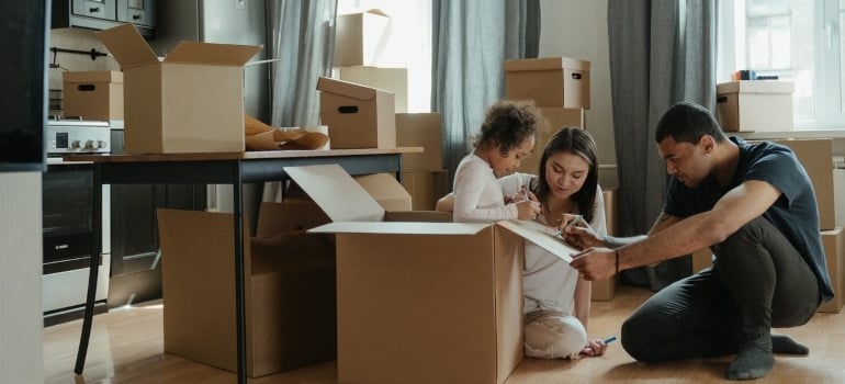 A family making an unpacking plan after moving a large household