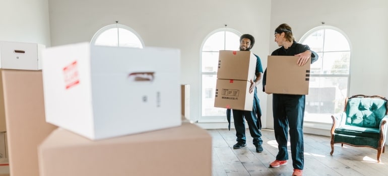 Two people using moving safety tips for proper lifting