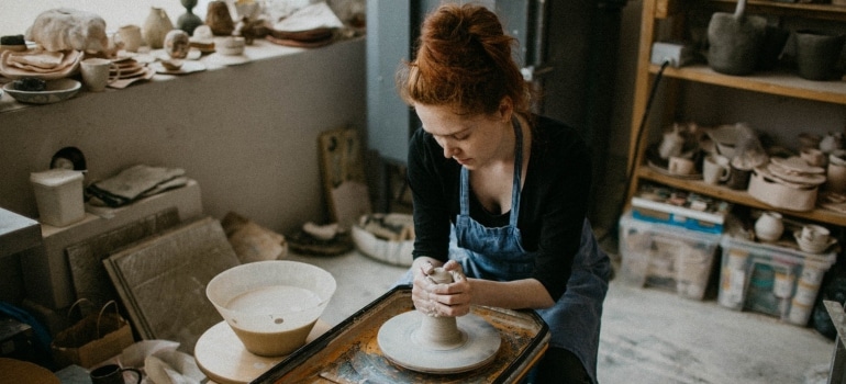 girl making a vase in pottery studio