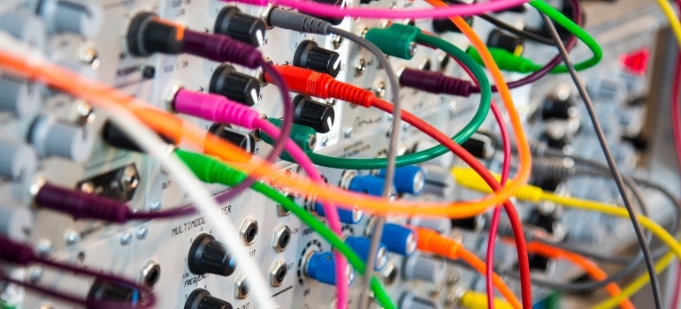 Cables in various colors connected to a device.