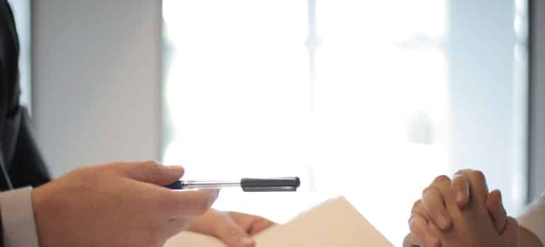 Business man giving contract to a woman