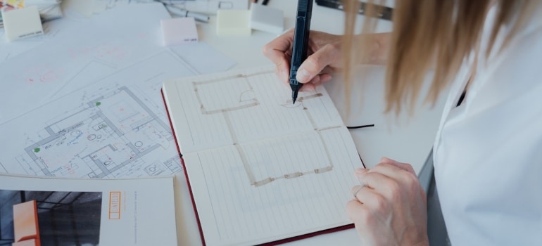 a woman making a floor plan