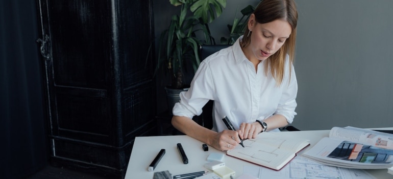 a woman calculating the costs of home remodeling in Miami