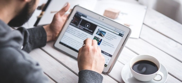 Man browsing the internet on his tablet 