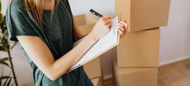 A woman writing an inventory before moving