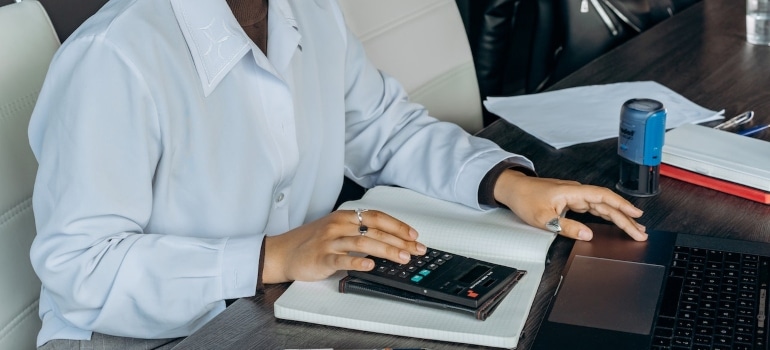 a woman calculating the costs of home remodeling in Miami