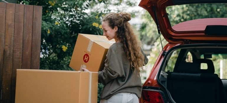 a woman carrying a box