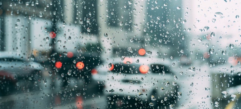 A lot of cars on the road during a rainy day.