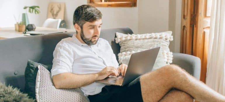 a man looking at the laptop and wondering how to find a new job after moving from Miami to Fort Lauderdale