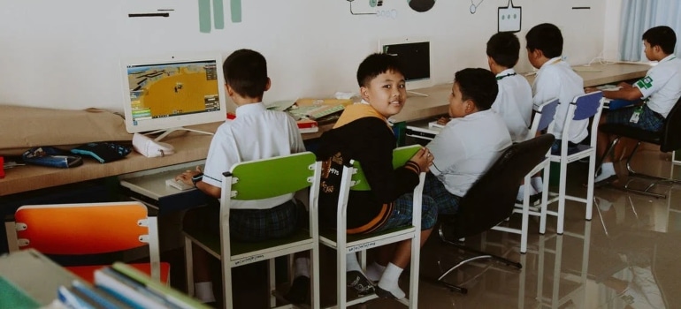 kids sitting on chairs at school