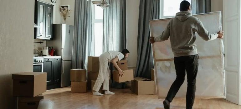 A man carrying a painting