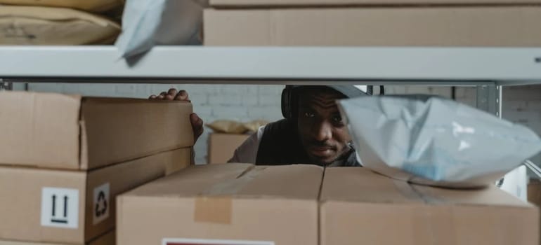 A man looking through boxes