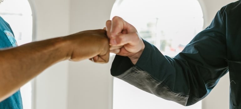Men greeting each other with fist bump