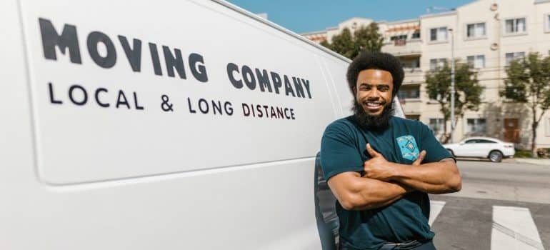 a mover standing next to the truck