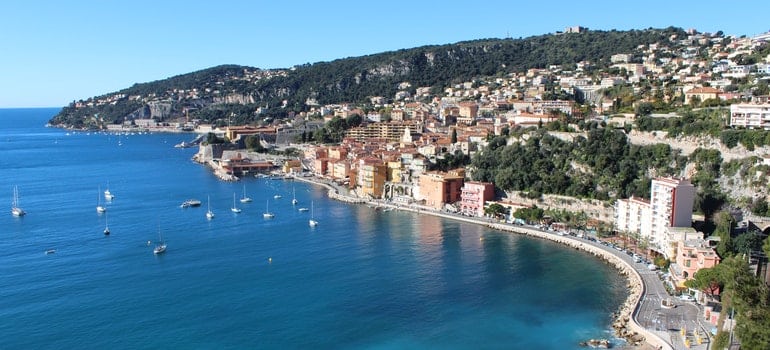 Residential Buildings in Front of Body of Water during Daytime