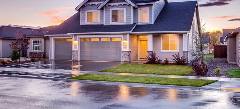 Blue and gray concrete house with a yard