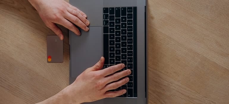 A person is using a credit card while shopping online.