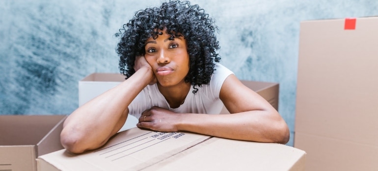 a worried woman wondering about mistakes people make when choosing movers