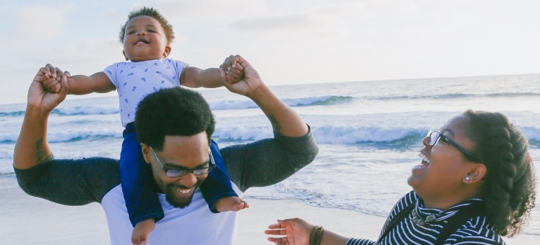 family sending time on beach - the post-move summer activities for families in Miami