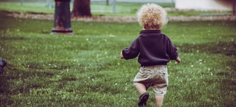 A toddler running on the playground