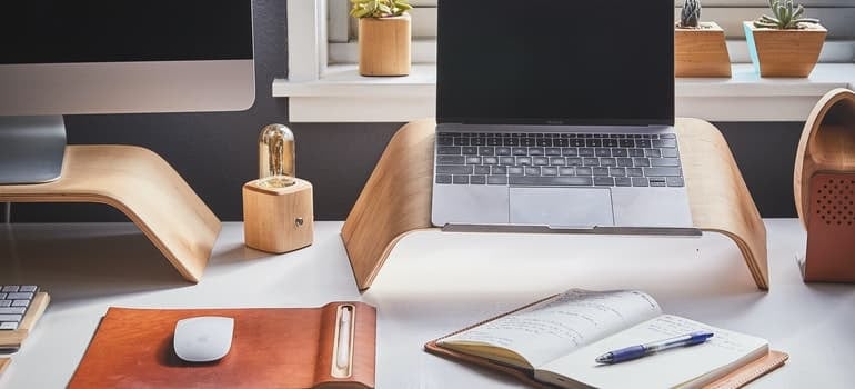 A desk, laptop and a notepad