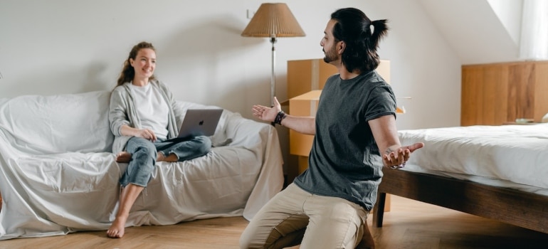 A woman searching the internet and a man with arms wide open