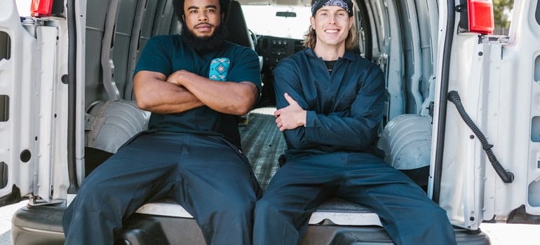 Two movers sitting in a van