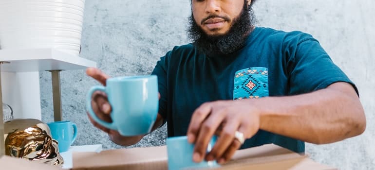 A man packing cups