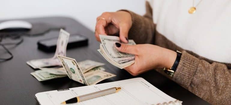 woman counting dollar bills