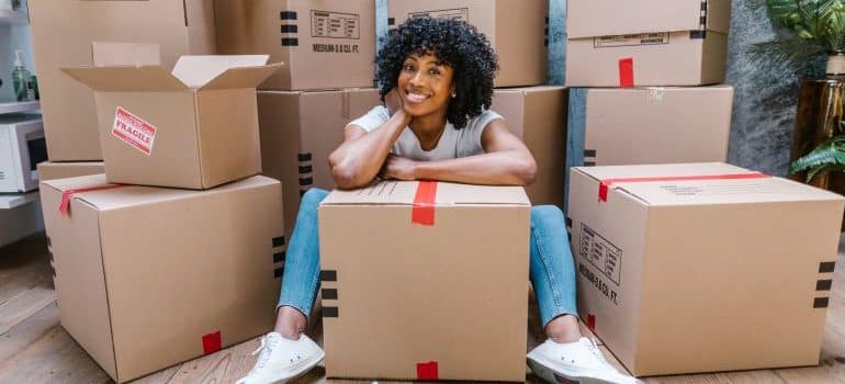 woman smiling because she was able to find quality packing supplies in Miami