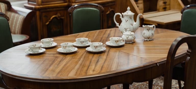 Vintage Porcelain Tea Set On Wooden Dining Table.