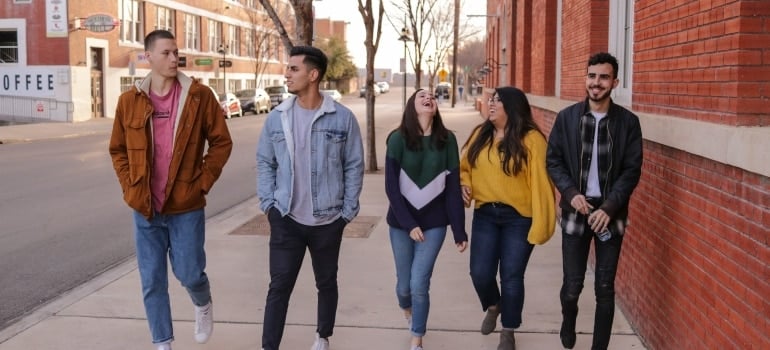 teenage friends walking on street