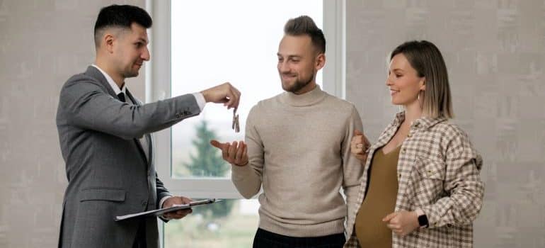 realtor handing keys to the buyer