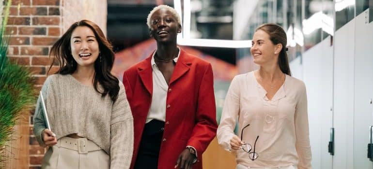 three women walking in the office