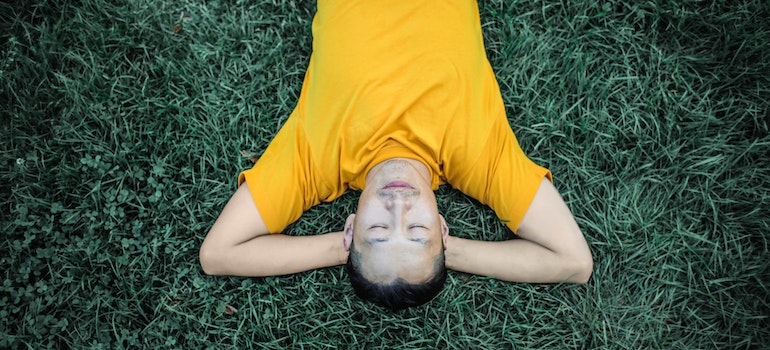 man Laying On Grass Field