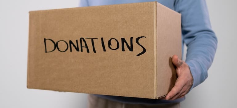 Man carrying a box of donations