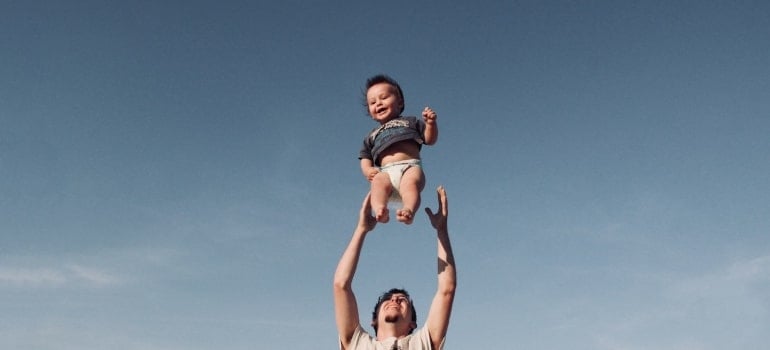 Picture of a man playing with a baby 