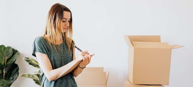 A woman writing down the inventory