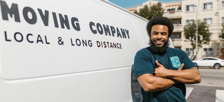 A mover in front of his moving van