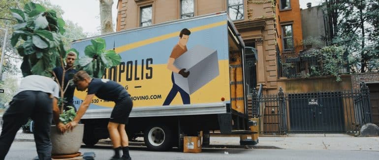 A moving company's truck on the driveway.