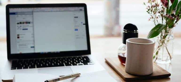 Laptop with a cup of coffee next to it