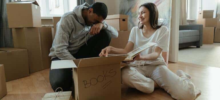 happy couple is unpacking books