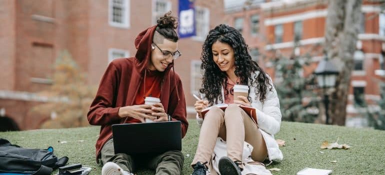 two students in front of campus