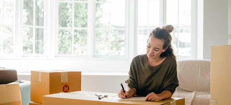 Woman packing expensive artwork for moving