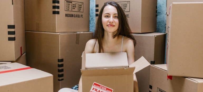 a woman and cardboard boxes