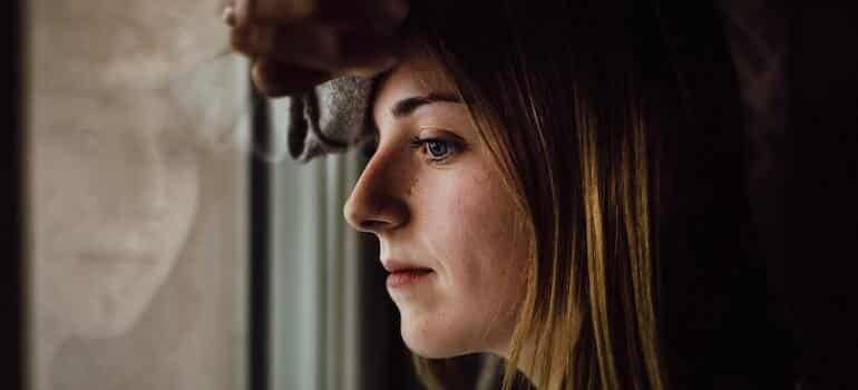 A woman leaning on a window