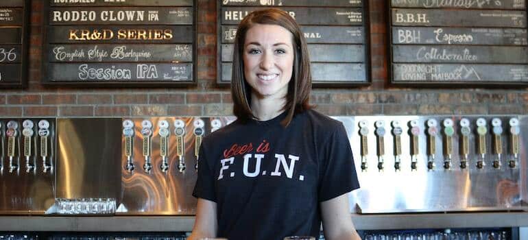 A waitress behind a table