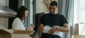 A family of two packing an oddly shaped item for their relocation.