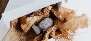 An oddly shaped figure of Buddha, something which would need special care when packing it for a move.