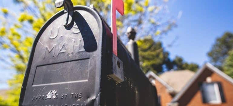 a black mailbox that should be changed in order to enhance your home's curb appeal before selling